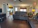 Living room with hardwood floors, brown couches, and a ceiling fan at 250 Joanne Dr, Davenport, FL 33897