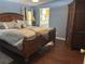 Main bedroom with large bed, hardwood floors and en-suite bathroom at 250 Joanne Dr, Davenport, FL 33897