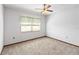 Simple bedroom with carpeted floors, a ceiling fan, and a window with blinds at 2643 Borinquen Dr, Kissimmee, FL 34744