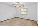 Bright bedroom with ceiling fan and neutral carpeting at 2643 Borinquen Dr, Kissimmee, FL 34744