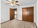 Spacious bedroom with double door closet and ceiling fan at 2643 Borinquen Dr, Kissimmee, FL 34744