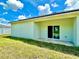 Back exterior view of house showing light green walls and covered patio at 2645 Sw 155Th Ln, Ocala, FL 34473