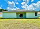 Rear view of house showcasing light green exterior and landscaping at 2645 Sw 155Th Ln, Ocala, FL 34473