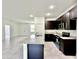 Modern kitchen with granite island and dark cabinetry at 2645 Sw 155Th Ln, Ocala, FL 34473