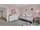 Light bedroom with a gray bed, white dresser, and pink walls at 2976 Moulin Rd, Davenport, FL 33837