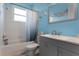 Clean bathroom with light blue walls, a shower/tub combo and gray vanity at 3063 Juneberry Ter, Oviedo, FL 32766