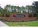 The Sanctuary community entrance, featuring a brick wall and landscaping at 3063 Juneberry Ter, Oviedo, FL 32766