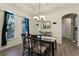 Elegant dining room featuring a glass-top table, four chairs, and hardwood floors at 3063 Juneberry Ter, Oviedo, FL 32766