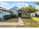 Welcoming front entrance with a brick walkway leading to a charming blue house at 3063 Juneberry Ter, Oviedo, FL 32766