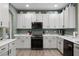 Modern kitchen with white cabinets, stainless steel appliances, and quartz countertops at 3063 Juneberry Ter, Oviedo, FL 32766