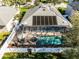 Aerial view of screened in pool with a spa and solar panels at 3063 Juneberry Ter, Oviedo, FL 32766