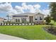 House exterior with a landscaped lawn and awning at 33431 Seattle Slew Dr, Sorrento, FL 32776