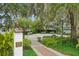 Scenic park with brick pathways, benches, and lush greenery at 33431 Seattle Slew Dr, Sorrento, FL 32776