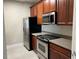 Modern kitchen with stainless steel appliances and wood cabinets at 3344 Robert Trent Jones Dr # 30505, Orlando, FL 32835