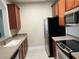 Modern kitchen with stainless steel appliances and wood cabinets at 3344 Robert Trent Jones Dr # 30505, Orlando, FL 32835