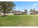 Tan house with a spacious yard and large tree at 4960 Se 37Th Ct, Ocala, FL 34480