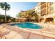 Resort-style pool with surrounding lounge chairs and building view at 501 Mirasol Cir # 306, Celebration, FL 34747