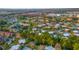 Wide aerial shot of a vibrant community with a mix of housing, trees, ponds, and a glimpse of a lake at 5368 Elm Ct # 354, Orlando, FL 32811