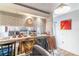 View of the breakfast bar leading to the kitchen with white cabinets at 5368 Elm Ct # 354, Orlando, FL 32811