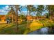 Scenic view of townhomes surrounded by lush greenery and trees, reflecting in the calm waters at 5368 Elm Ct # 354, Orlando, FL 32811