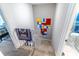 Carpeted staircase with white railing leads down, colorful modern art on the landing's wall at 5368 Elm Ct # 354, Orlando, FL 32811