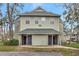 Two-story condo exterior with green siding and a covered entrance and mature landscaping at 6034 Westgate Dr # 202, Orlando, FL 32835