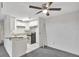 Modern kitchen adjacent to an empty dining area featuring a ceiling fan at 6034 Westgate Dr # 202, Orlando, FL 32835