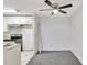 Modern kitchen adjacent to an empty dining area featuring a ceiling fan at 6034 Westgate Dr # 202, Orlando, FL 32835