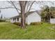 Side view of a single-story home showcasing the exterior and surrounding yard at 611 Bay Ave, Holly Hill, FL 32117