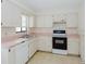 Bright kitchen featuring white cabinets, a black oven, and a practical layout for cooking at 611 Bay Ave, Holly Hill, FL 32117