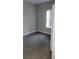 Empty bedroom with gray walls and gray wood-look tile floors at 615 N Delmonte Ct, Kissimmee, FL 34758