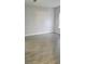 Empty living room with gray walls and wood-look tile floors at 615 N Delmonte Ct, Kissimmee, FL 34758