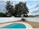 Relaxing pool area with large shade tree and a spacious backyard at 6642 Matchett Rd, Orlando, FL 32809