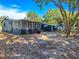 Gray house with screened porch and a large backyard at 6952 Sw 85Th Pl, Ocala, FL 34476