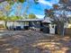 Gray house with screened porch, detached garage, and spacious yard at 6952 Sw 85Th Pl, Ocala, FL 34476