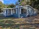 Gray mobile home with white shutters and covered porch at 6952 Sw 85Th Pl, Ocala, FL 34476