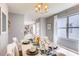 Dining area with a table set for a meal and a view into the kitchen at 7055 Carib Grackle Dr, St Cloud, FL 34773