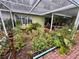 Lush garden with covered patio, perfect for relaxation at 824 Lake Elbert Ct, Winter Haven, FL 33881