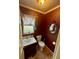 Small powder room with decorative wallpaper at 824 Lake Elbert Ct, Winter Haven, FL 33881