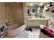 Bathroom with corner bathtub, vanity, and window at 824 Lake Elbert Ct, Winter Haven, FL 33881