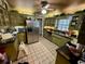 Galley kitchen with green cabinets, stainless steel appliances, and granite counters at 824 Lake Elbert Ct, Winter Haven, FL 33881