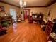 Living room featuring hardwood floors, fireplace, and antique decor at 824 Lake Elbert Ct, Winter Haven, FL 33881