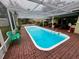 Relaxing rectangular pool with covered patio and seating at 824 Lake Elbert Ct, Winter Haven, FL 33881