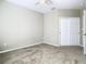 Well-lit bedroom with double door closet and carpet at 8276 Maritime Flag St # 201, Windermere, FL 34786