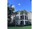 Building exterior showcasing a three-story building with palm trees at 8276 Maritime Flag St # 201, Windermere, FL 34786