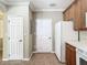 Kitchen features wood cabinets, white appliances, and tile flooring at 8276 Maritime Flag St # 201, Windermere, FL 34786