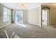 Living room with balcony access and neutral color scheme at 8276 Maritime Flag St # 201, Windermere, FL 34786