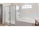 Bathroom with soaking tub and walk-in shower at 841 Greenshank Dr, Haines City, FL 33844