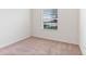 Well-lit bedroom featuring carpet flooring and window at 841 Greenshank Dr, Haines City, FL 33844