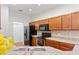 Clean kitchen featuring wood cabinets and granite counters at 841 Greenshank Dr, Haines City, FL 33844